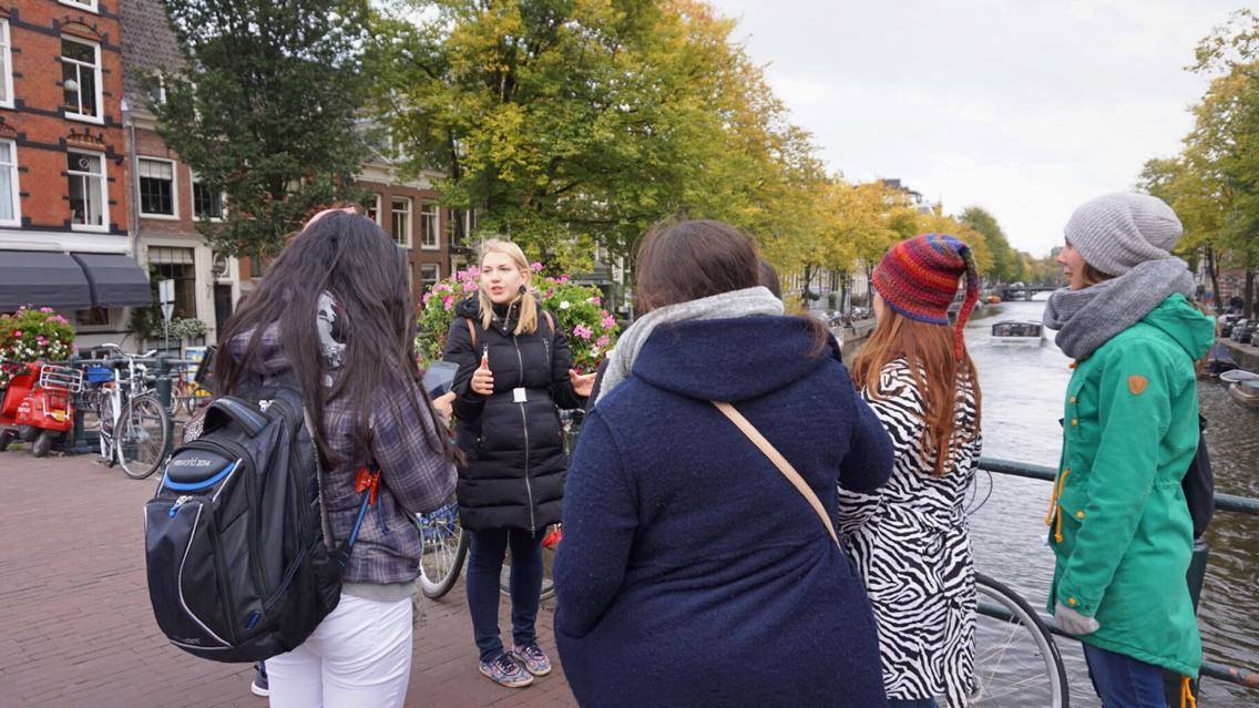 tour guide leading tour through Amsterdam