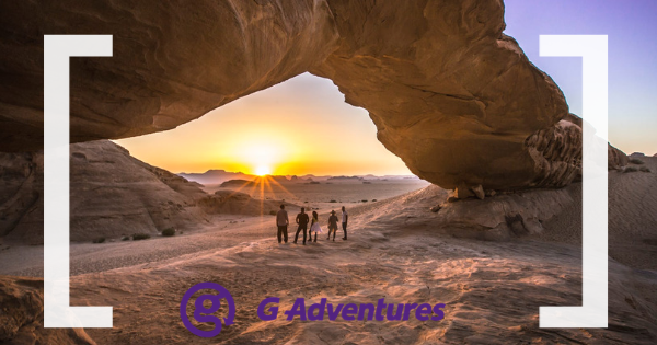 G Adventures branding and people standing into sunset