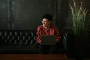 Woman smiling at computer screen