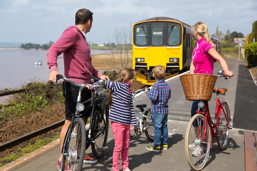 Estuary view, train stopping at exton station- family and bikes waiting